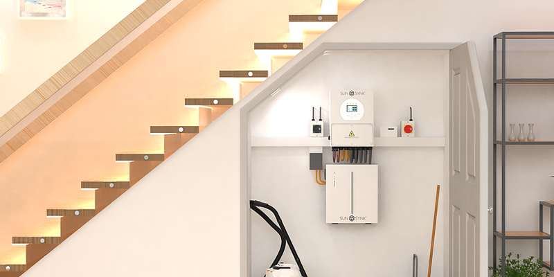 Sunsynk hybrid solar inverter and battery system neatly installed under a staircase in a modern UK home interior